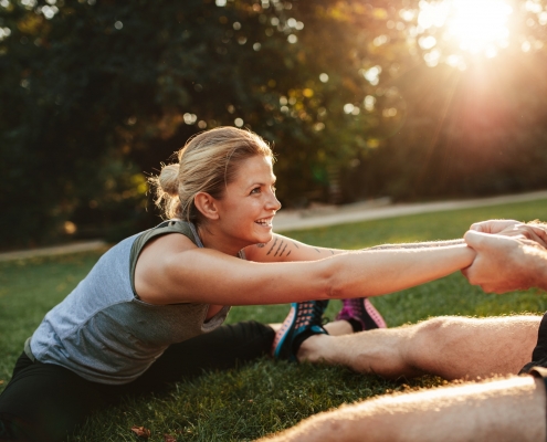 Young health couple exercising in park