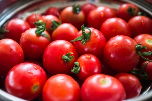 Red tomatoes background. Group of tomatoes in a plate