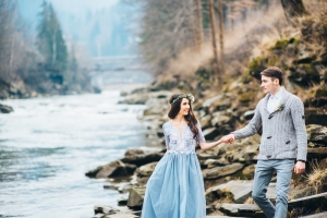 young couple in love on a mountain river