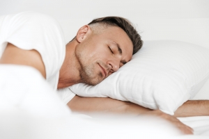 Handsome man sleeping in bed