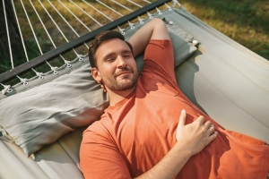 Man napping in hammock in nature